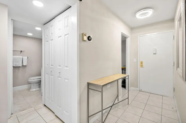 a spacious bathroom with a granite countertop sink a toilet and a mirror