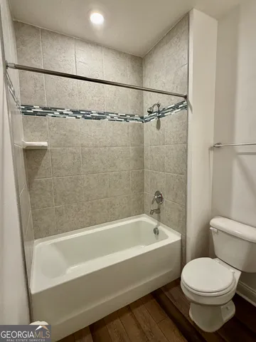 an empty room with windows and ceiling fan view