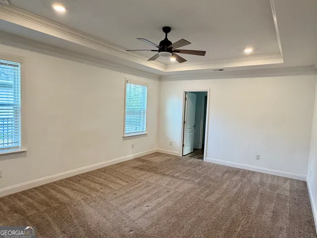 a bathroom with a granite countertop sink a mirror and shower