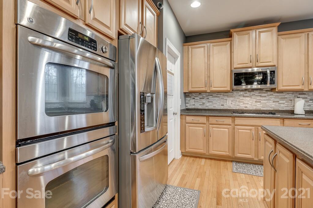 415 Fischer Road Fort Mill, SC 29715 - Photo 13 of 48 a kitchen with stainless steel appliances granite countertop a refrigerator and a stove top oven