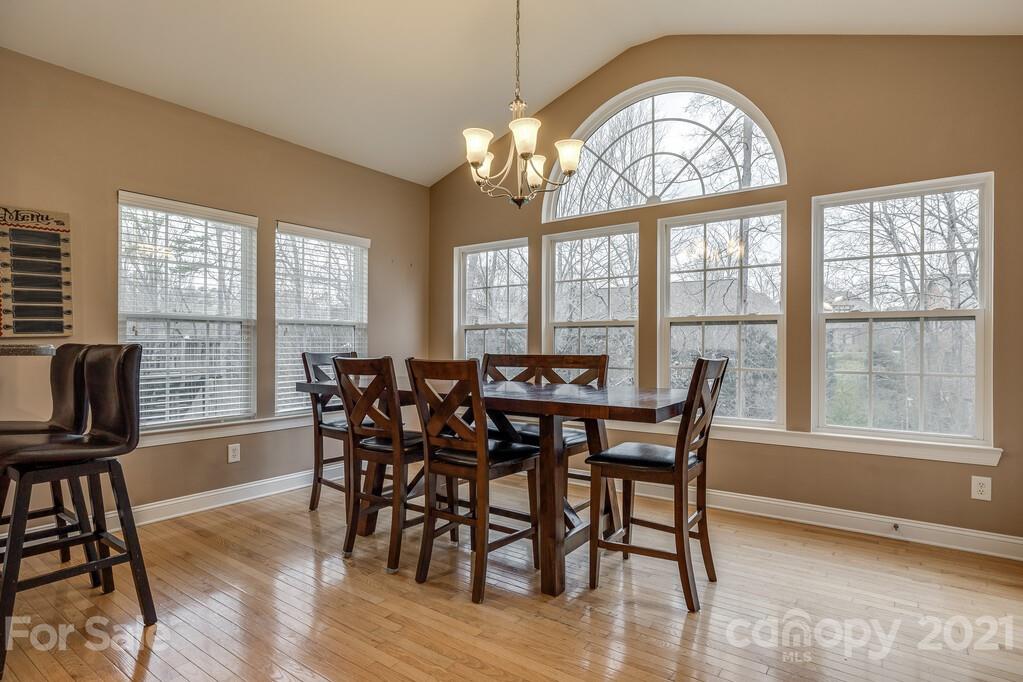 415 Fischer Road Fort Mill, SC 29715 - Photo 14 of 48 a view of a dining room with furniture a chandelier and wooden floor