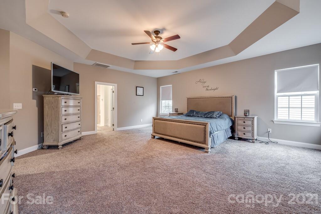 415 Fischer Road Fort Mill, SC 29715 - Photo 21 of 48 a spacious bedroom with a bed and a flat screen tv