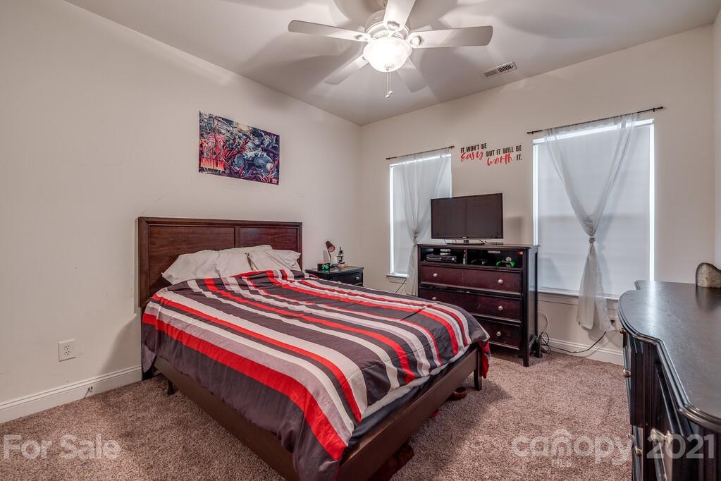 415 Fischer Road Fort Mill, SC 29715 - Photo 29 of 48 a bedroom with a bed and a flat screen tv