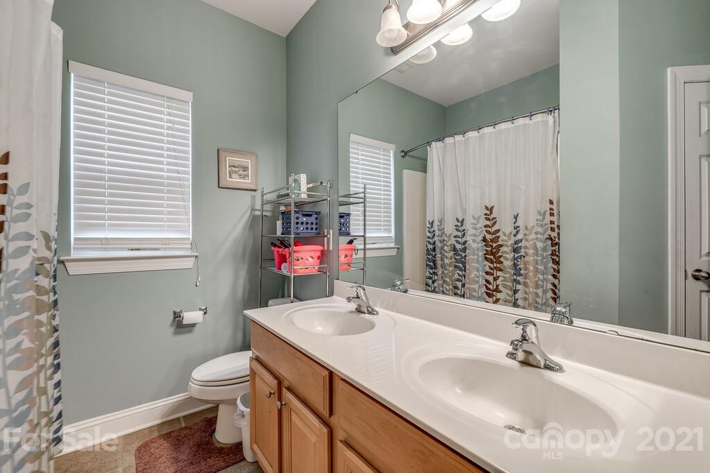 415 Fischer Road Fort Mill, SC 29715 - Photo 30 of 48 a bathroom with a sink toilet vanity and window