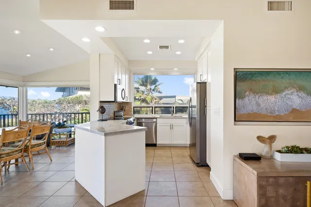 a kitchen with a stove a refrigerator and a sink