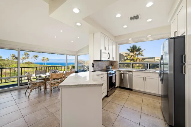 a kitchen with appliances cabinets and a counter top space