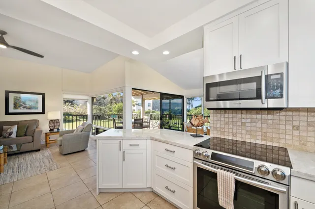 a kitchen that has a sink and a stove top oven