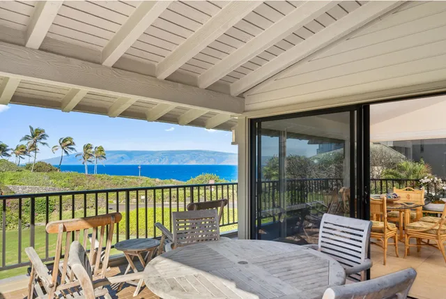 a balcony with furniture and garden view