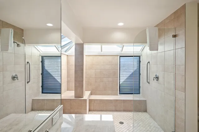 a bathroom with a glass shower door and a bathtub