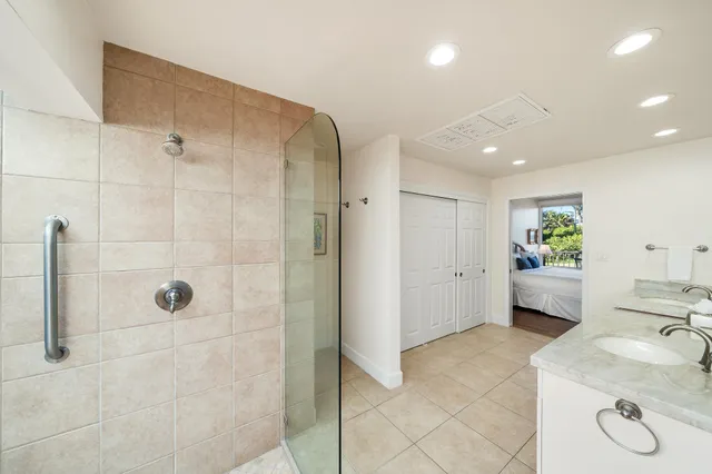 a en suite bathroom with a granite countertop sink a toilet and shower