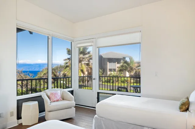 a bedroom with a large window and a bed