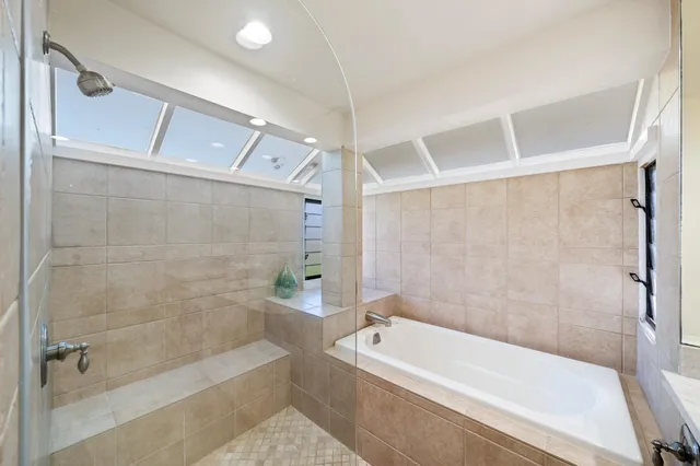 a bathroom with a bathtub and a shower