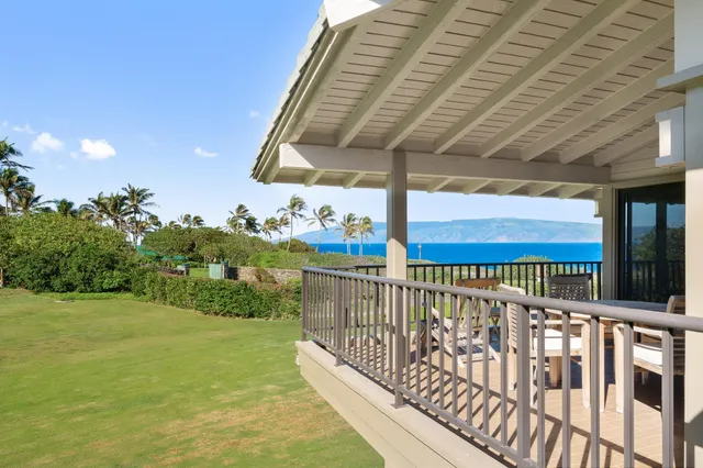 a view of a balcony with two chairs and a table