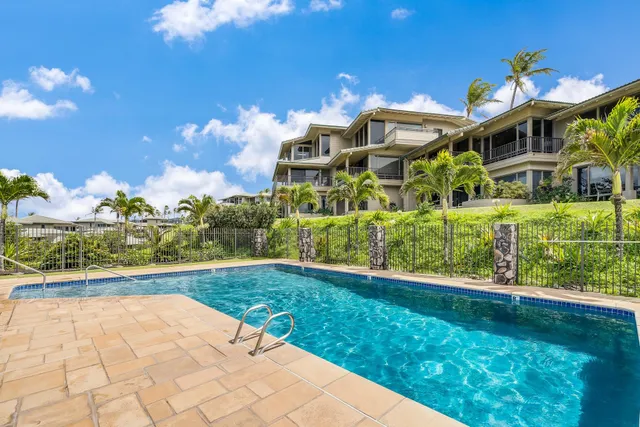 a view of a swimming pool with a yard