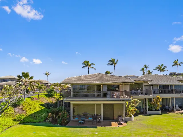 a view of an house with swimming pool and chairs