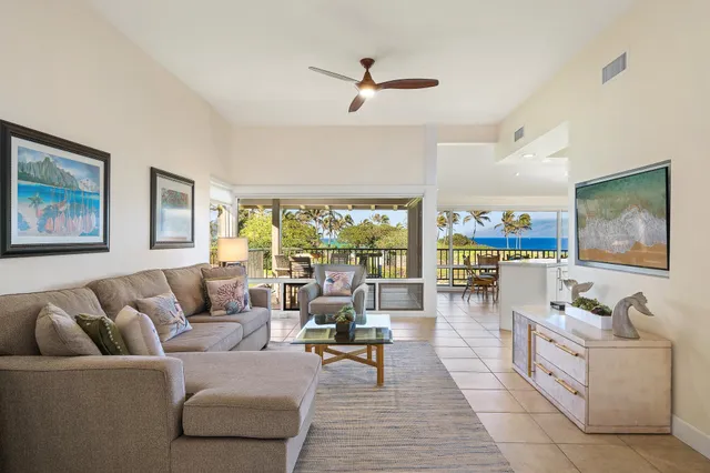 a living room with furniture ceiling fan and a rug
