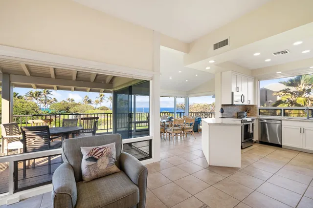 a kitchen with a large window in a living room
