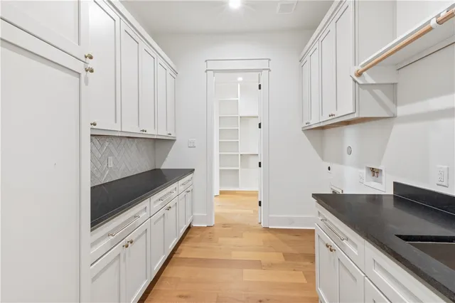 a kitchen with granite countertop a sink and a stove top oven