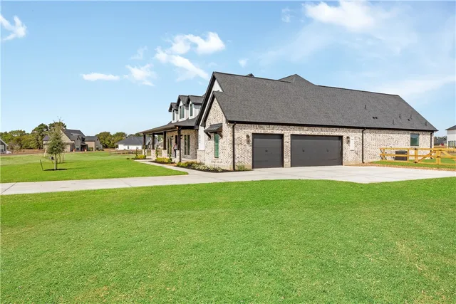 a view of a house with a garden and yard