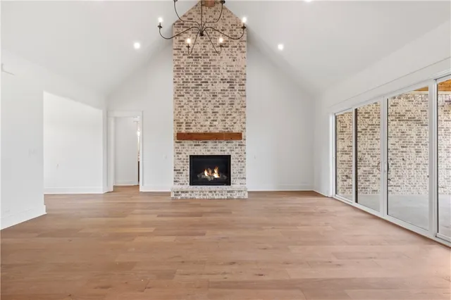a view of an empty room with a fireplace and a window