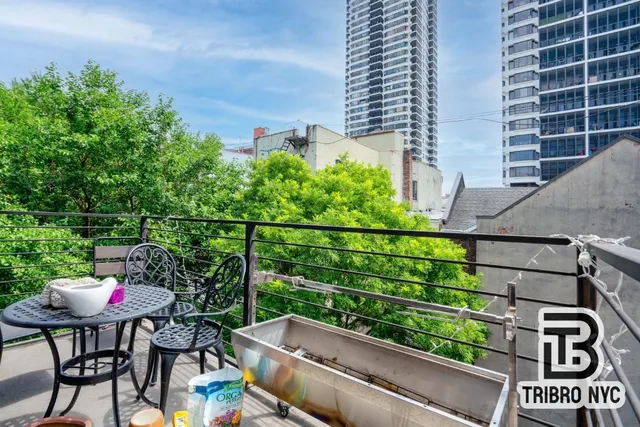 a view of a chairs and table in the back yard of the house