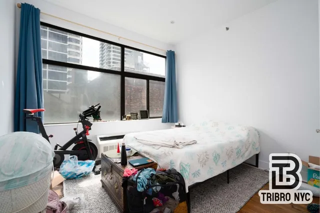 a bed room with a bed and a window