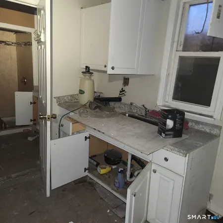a room with water heater and wooden racks