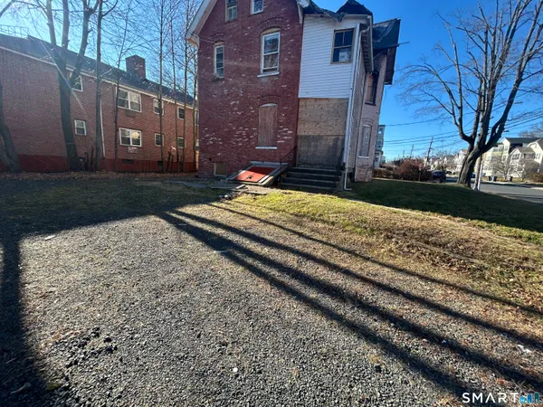 a pathway of a house with a yard