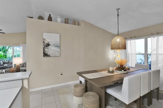 a room with a table chairs and a window