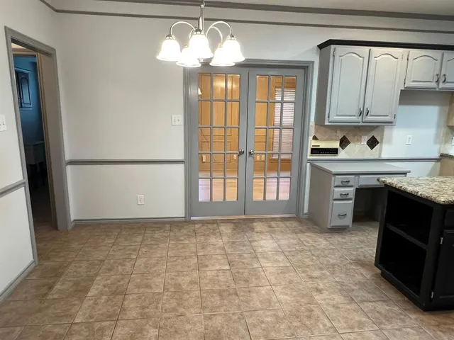 a view of a kitchen with a sink and a refrigerator