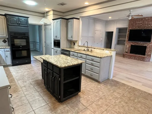 a kitchen with stainless steel appliances granite countertop a stove oven and a refrigerator