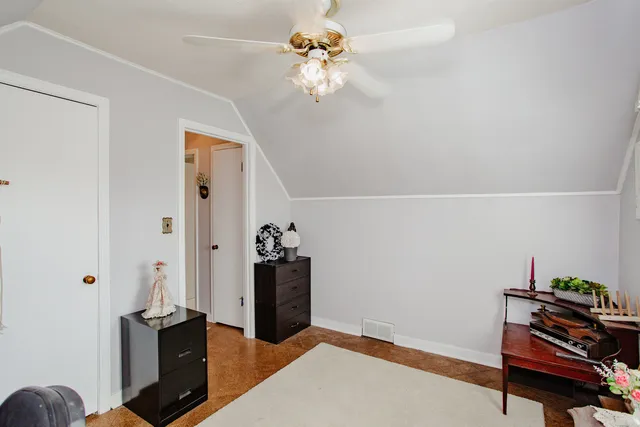 a view of a workspace with furniture and a chandelier fan
