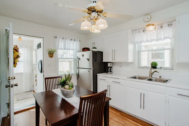 a kitchen with refrigerator cabinets and dining table