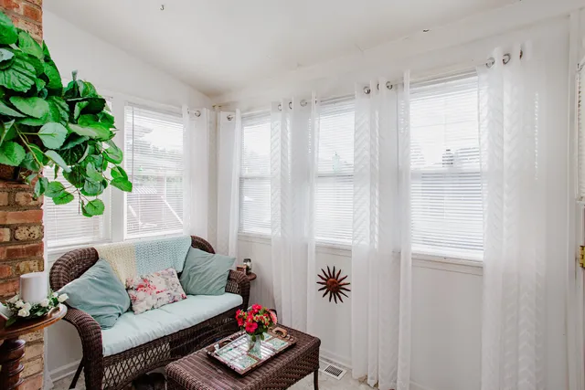 a living room with furniture and a potted plant