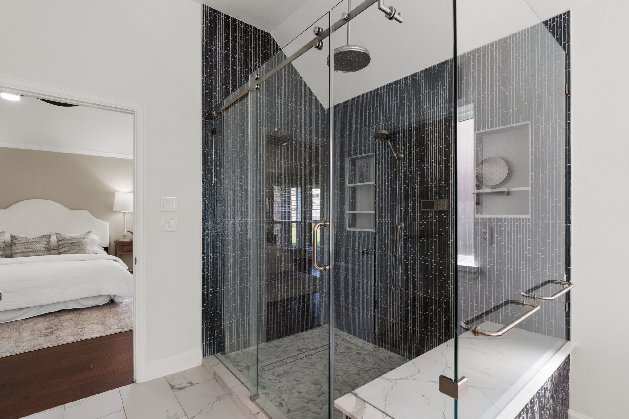 3426 Summer Ranch Drive Katy, TX 77494 - Photo 25 of 48 The primary bathroom features a sleek glass-enclosed walk-in shower with modern tile finishes, offering a clean, spa-inspired space designed for everyday comfort.