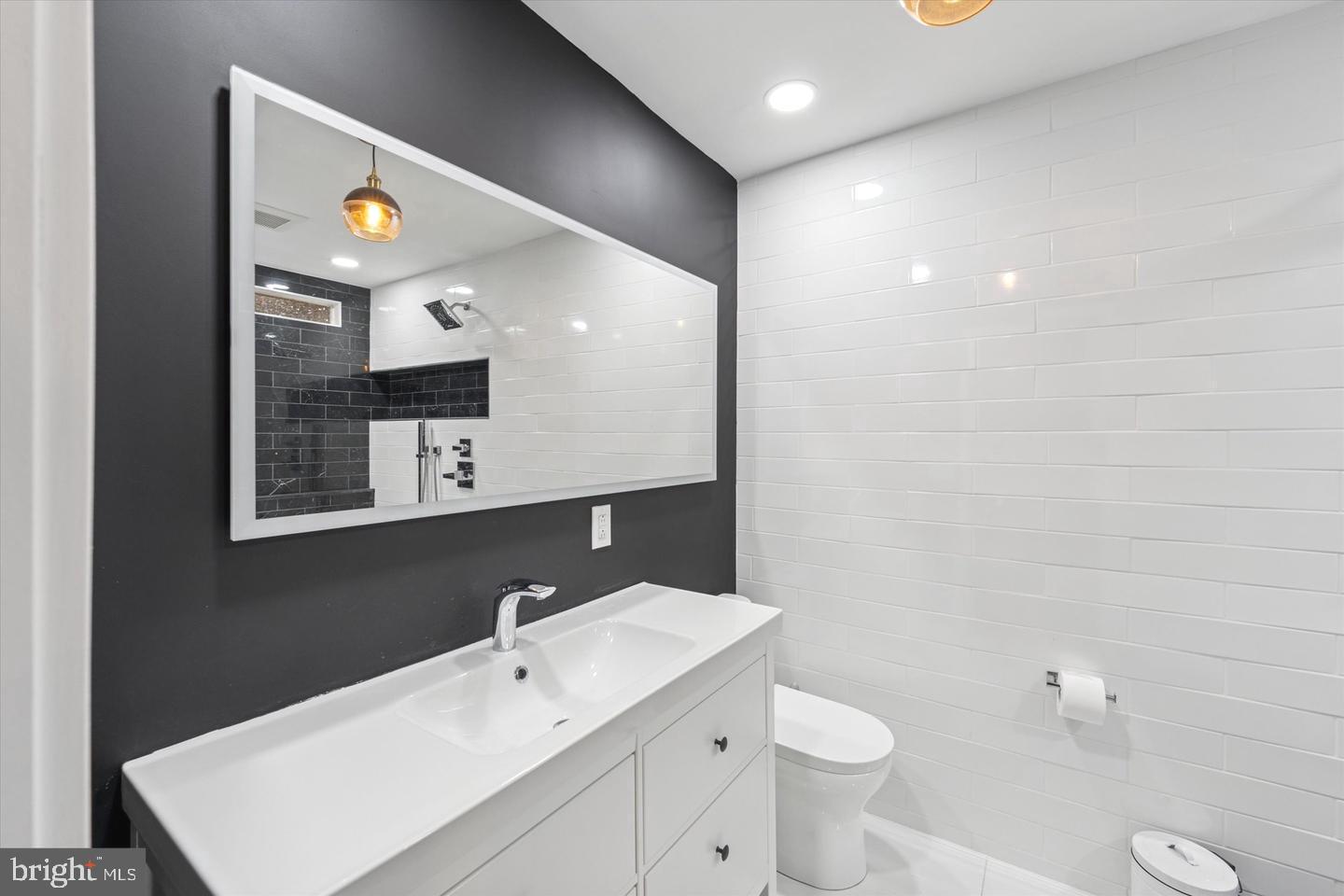 635 North 13th Street, Unit A Philadelphia, PA 19123 - Photo 14 of 17 a bathroom with a toilet sink and mirror