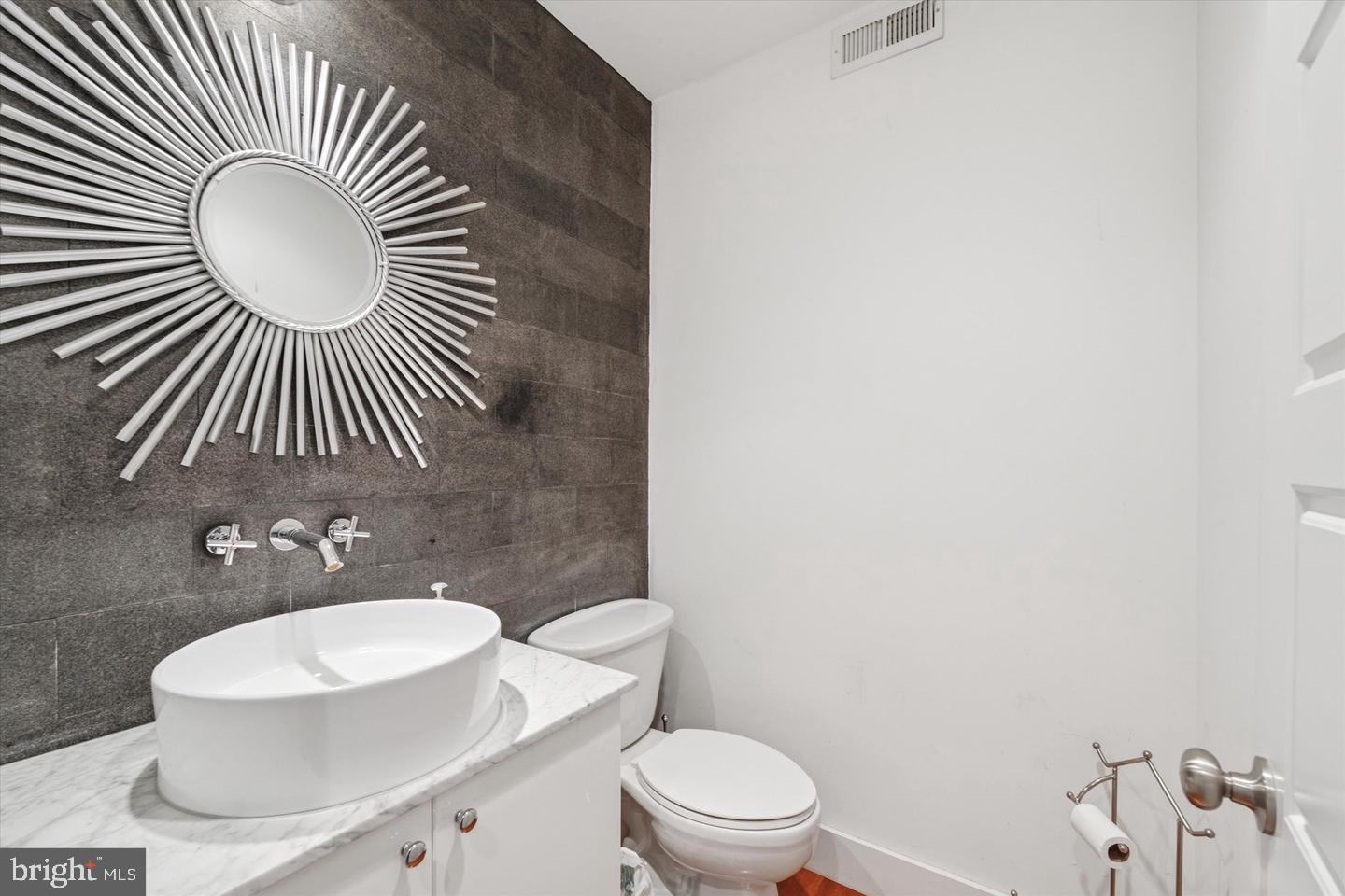 635 North 13th Street, Unit A Philadelphia, PA 19123 - Photo 6 of 17 a bathroom with a toilet a sink and mirror