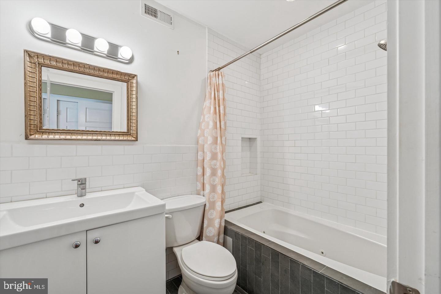 635 North 13th Street, Unit A Philadelphia, PA 19123 - Photo 7 of 17 a bathroom with a toilet a sink and bathtub