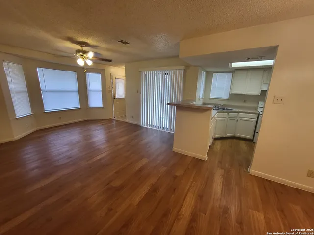a view of a kitchen with wooden floor and a sink