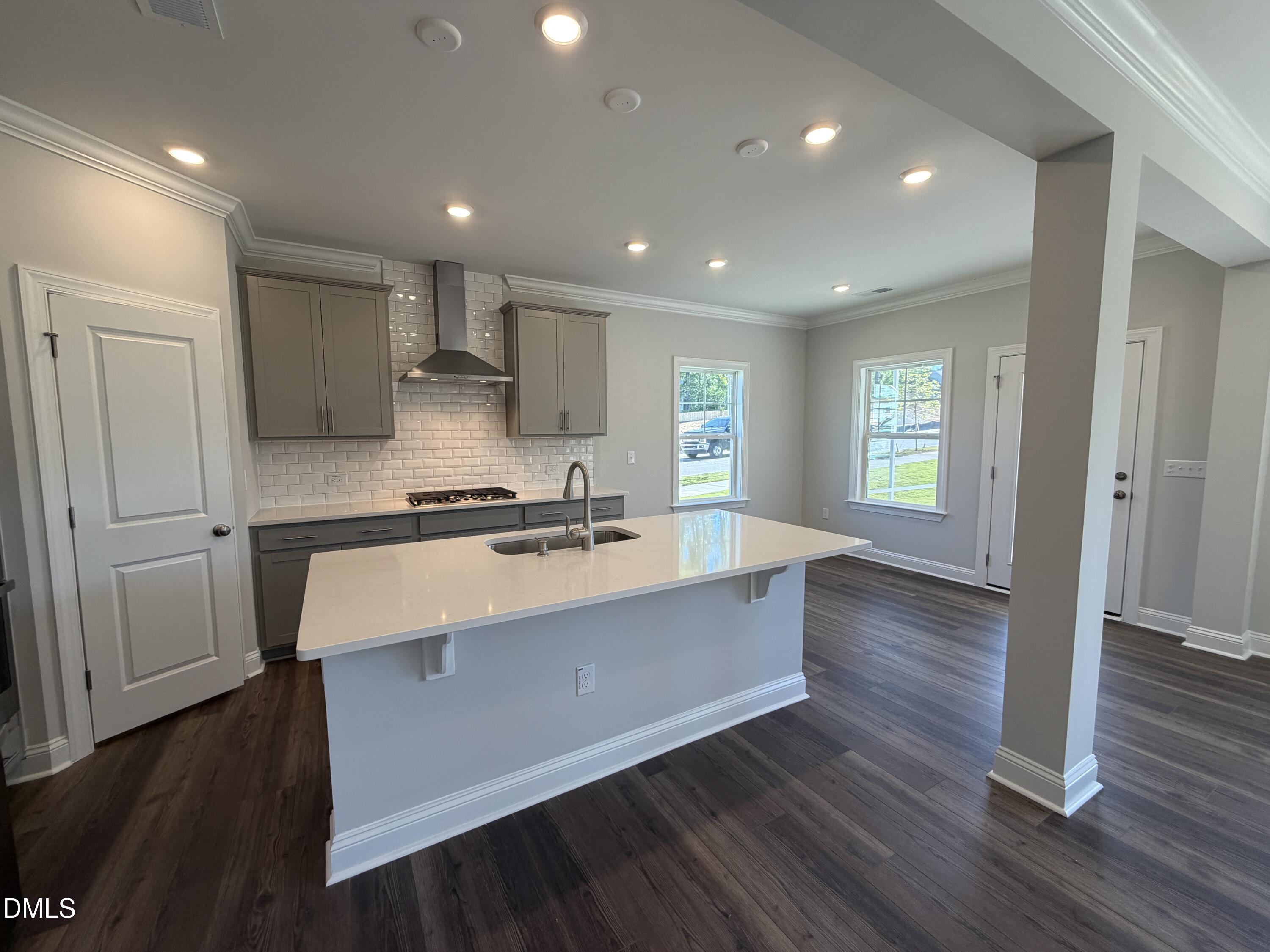 3016 Sandy Bluff Road Raleigh, NC 27616 - Photo 7 of 34 a large kitchen with kitchen island a sink dishwasher stove and wooden floor