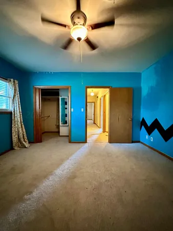 a view of an empty room with a ceiling fan