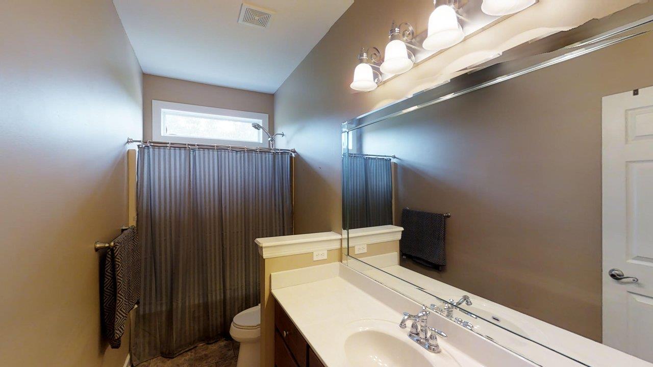 919 Sam Johnson Road Columbia, TN 38401 - Photo 17 of 29 a bathroom with a sink vanity mirror and toilet