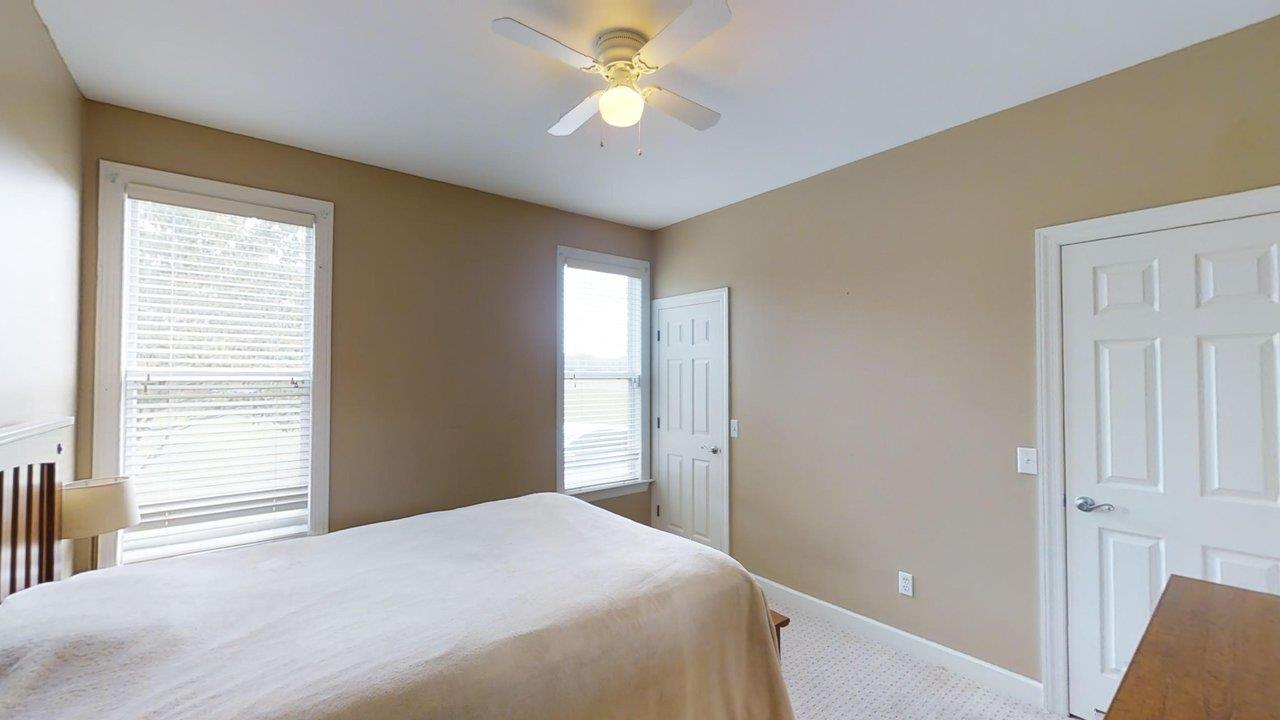 919 Sam Johnson Road Columbia, TN 38401 - Photo 18 of 29 a bedroom with a bed and a chandelier