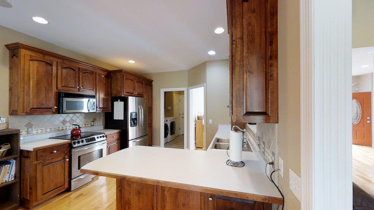 919 Sam Johnson Road Columbia, TN 38401 - Photo 6 of 29 a kitchen with stainless steel appliances granite countertop a sink dishwasher a refrigerator and a stove with wooden floor