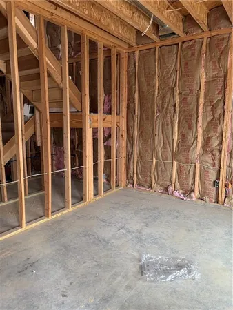 a view of an empty room with wooden fence