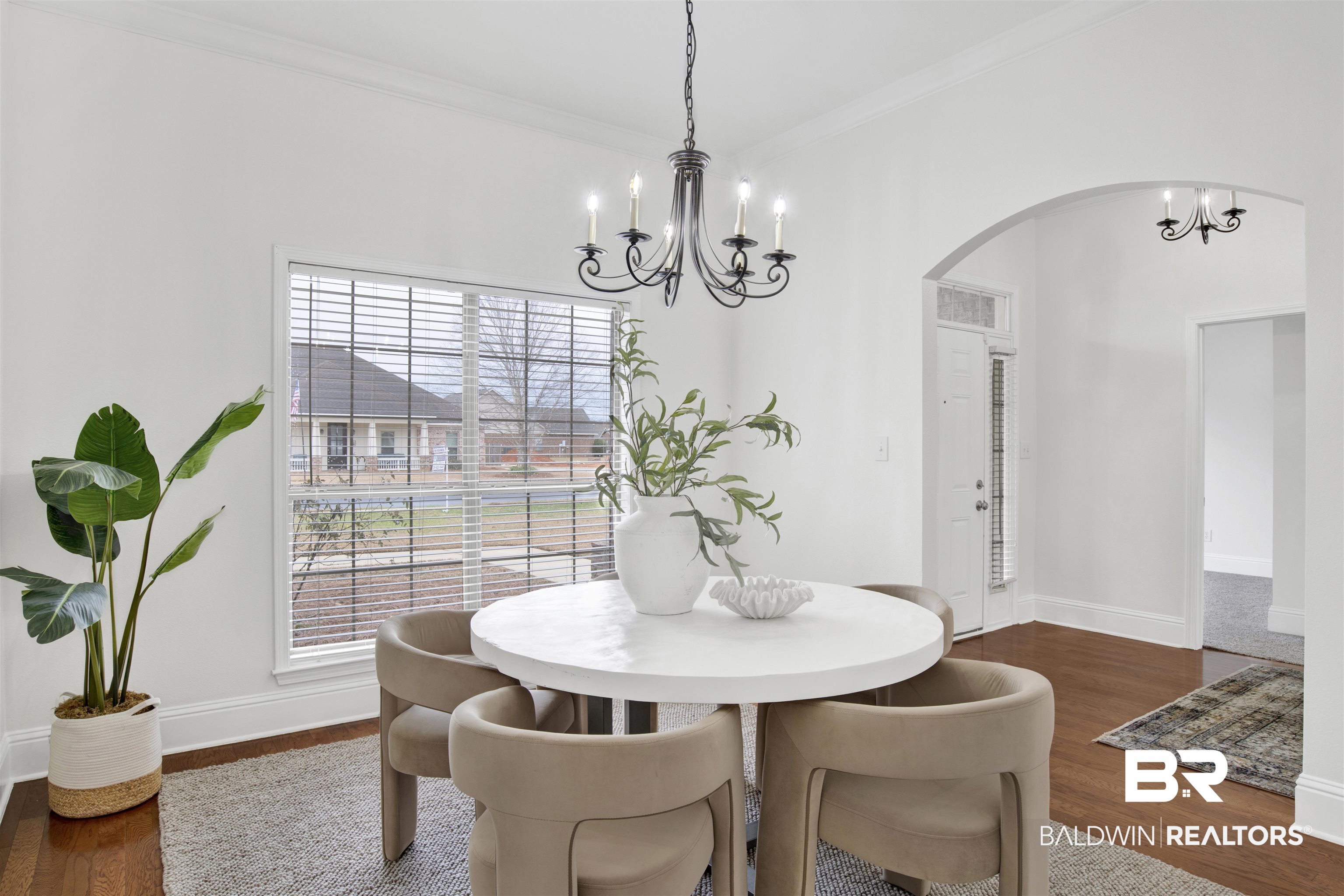 25350 Spindle Lane Daphne, AL 36526 - Photo 4 of 32 Dining area with ornamental molding, dark hardwood / wood-style flooring, and an inviting chandelier