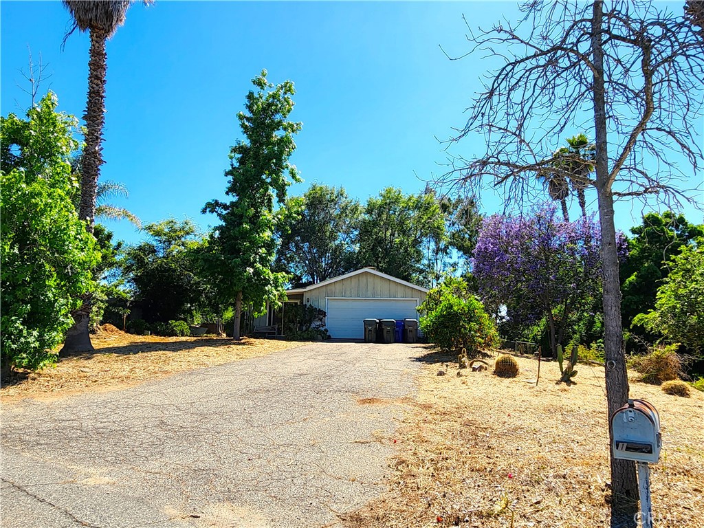 1603 Parvenu Lane Fallbrook, CA 92028 - Photo 1 of 1 a yellow house with trees in front of it