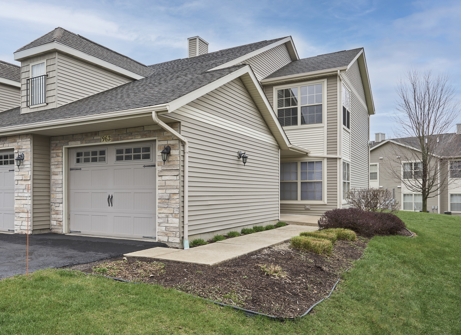 a front view of a house with a garden