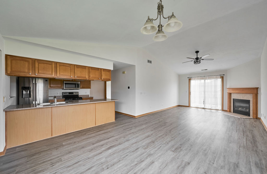 962 Arvle Circle, Unit 962 Sycamore, IL 60178 - Photo 12 of 18 a kitchen with stainless steel appliances granite countertop a sink cabinets and wooden floor