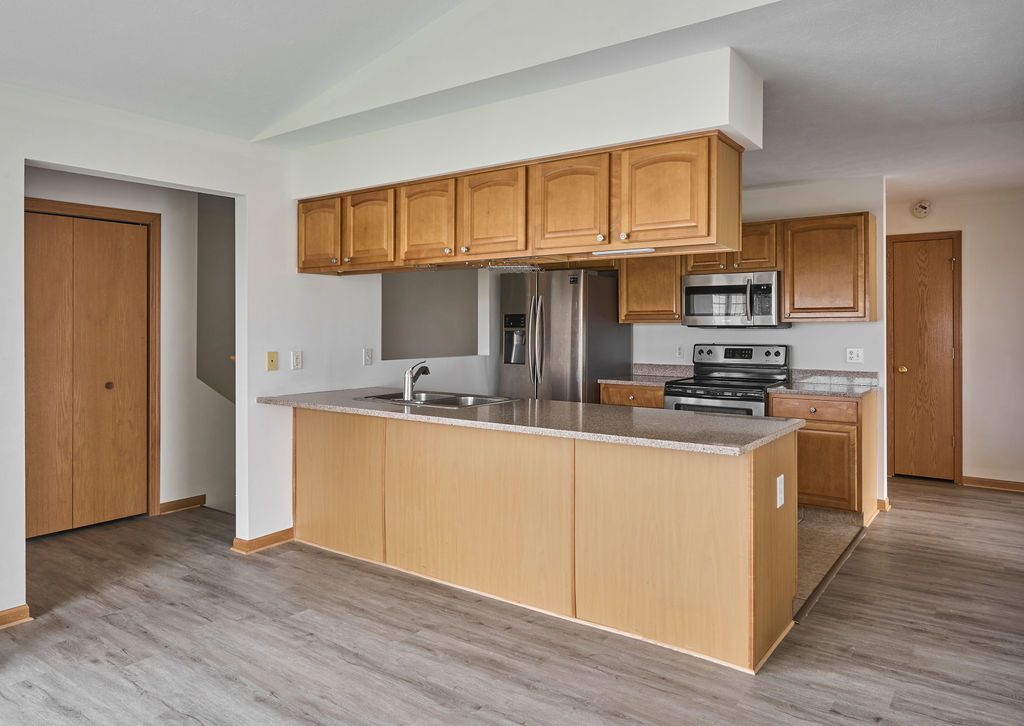 962 Arvle Circle, Unit 962 Sycamore, IL 60178 - Photo 4 of 18 a kitchen with stainless steel appliances granite countertop a stove a sink and a refrigerator